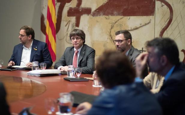 El presidente de la Generalitat, Carles Puigdemont (d) y el vicepresidente, Oriol Junqueras (i).