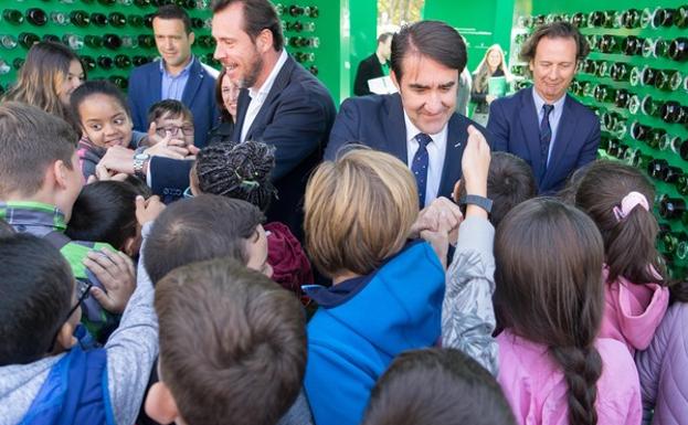 El consejero de Fomento y Medio Ambiente, Juan Carlos Suárez-Quiñones; el alcalde de Valladolid, Óscar Puente; el director de gerencias y cuentas clave de Ecovidrio, Félix Reneses; y la concejala de Medio Ambiente, María Sánchez, saludan a niños en la exposición conmemorativa de los 20 añazos del reciclaje de envases de vidrio en Castilla y León. 