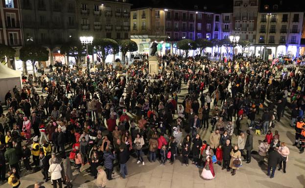 Imagen principal - Aspecto de la Plaza Mayor instantes antes de comenzar el pregón (arriba), una peñista de BurgoSalsón entrega una vaso de sopas de ajo a una pareja (izquierda) y Romina Ventín, leyendo el pregón.