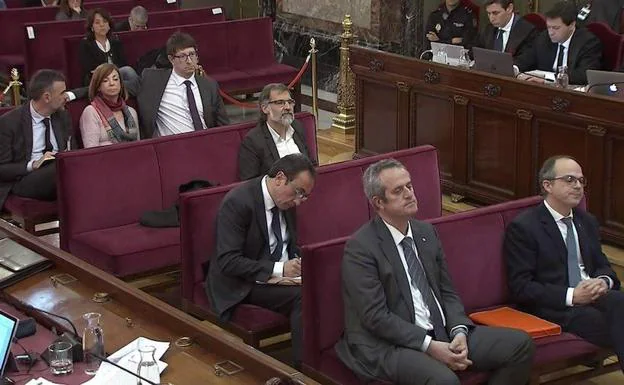 Jordi Turull (d), y Joaquim Forn (i) en primera fila junto a otros acusados en el juicio del 'procés'.