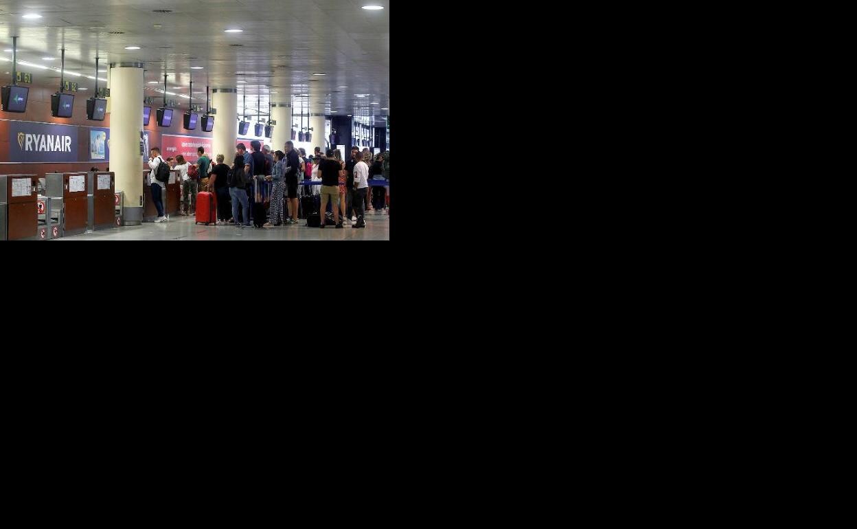 Colas de viajeros ante los mostradores de Ryanair, en el aeropuerto de Barcelona-El Prat. 