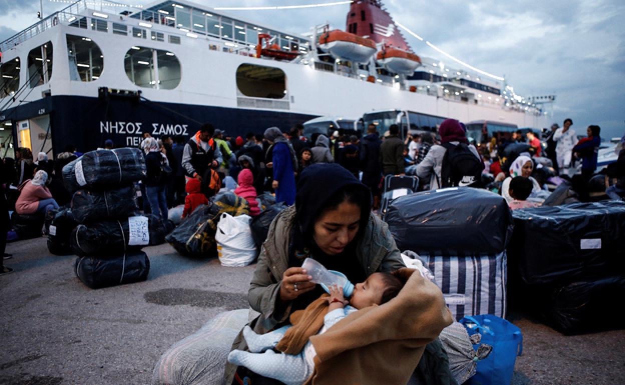 Una mujer alimenta a su bebé tras desembarcar de un ferry con 453 refugiados y migrantes. 