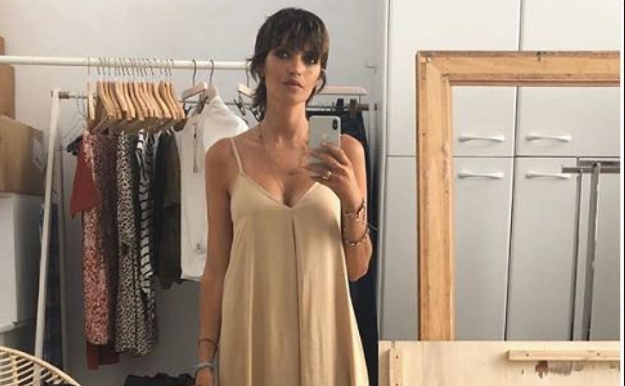 Vestido holgado y largo en color beige con escote de pico, tirantes finos ajustables y lazada en la espalda de su propio sello. A la venta por 70 euros.