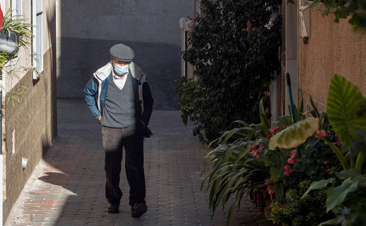 Un hombre pasea con una mascarilla debido a la covid-19. 