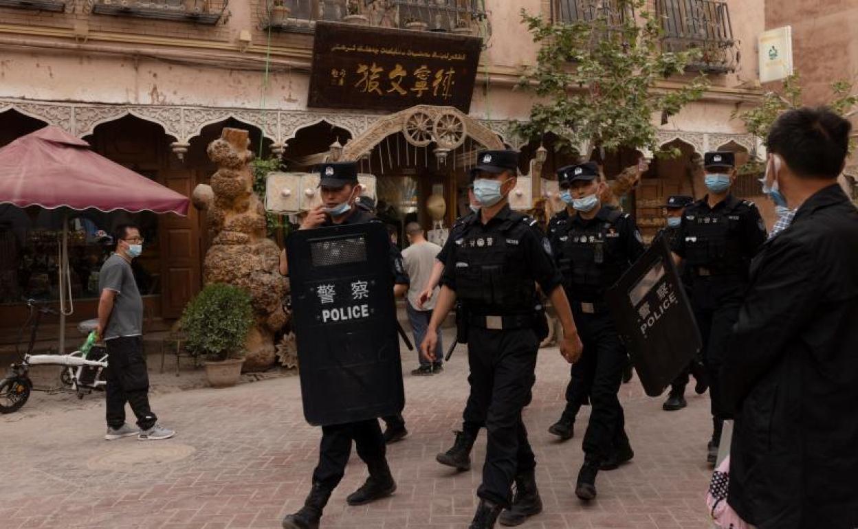 Policías patrullan una calle de la ciudad de Kashgar, en la región musulmana de Xinjiang.