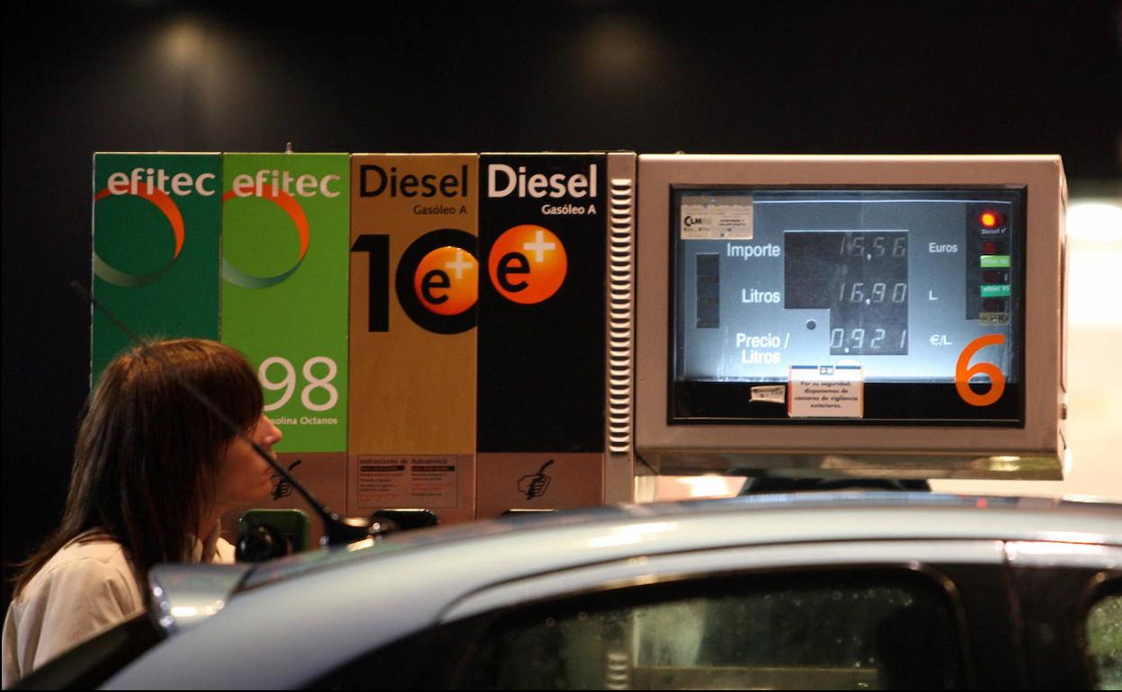 Una mujer llena el depósito de su automóvil en una gasolinera de Madrid. 