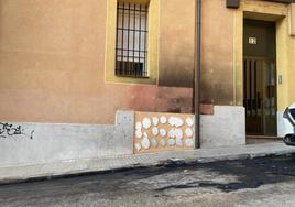 Los restos de los últimos coches incendiados aún siguen en la acera de la calle Emperador.