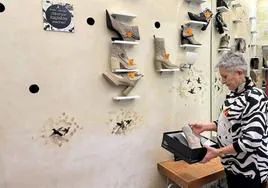 Carmen Gómez, hija de Francisco 'Paco' y última regente de Calzados Paco, observa con nostalgia uno de los zapatos que aún quedan en la tienda