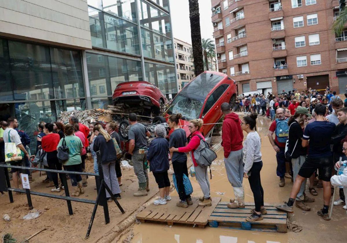 Varias personas esperan para recibir ayuda este jueves en Paiporta.