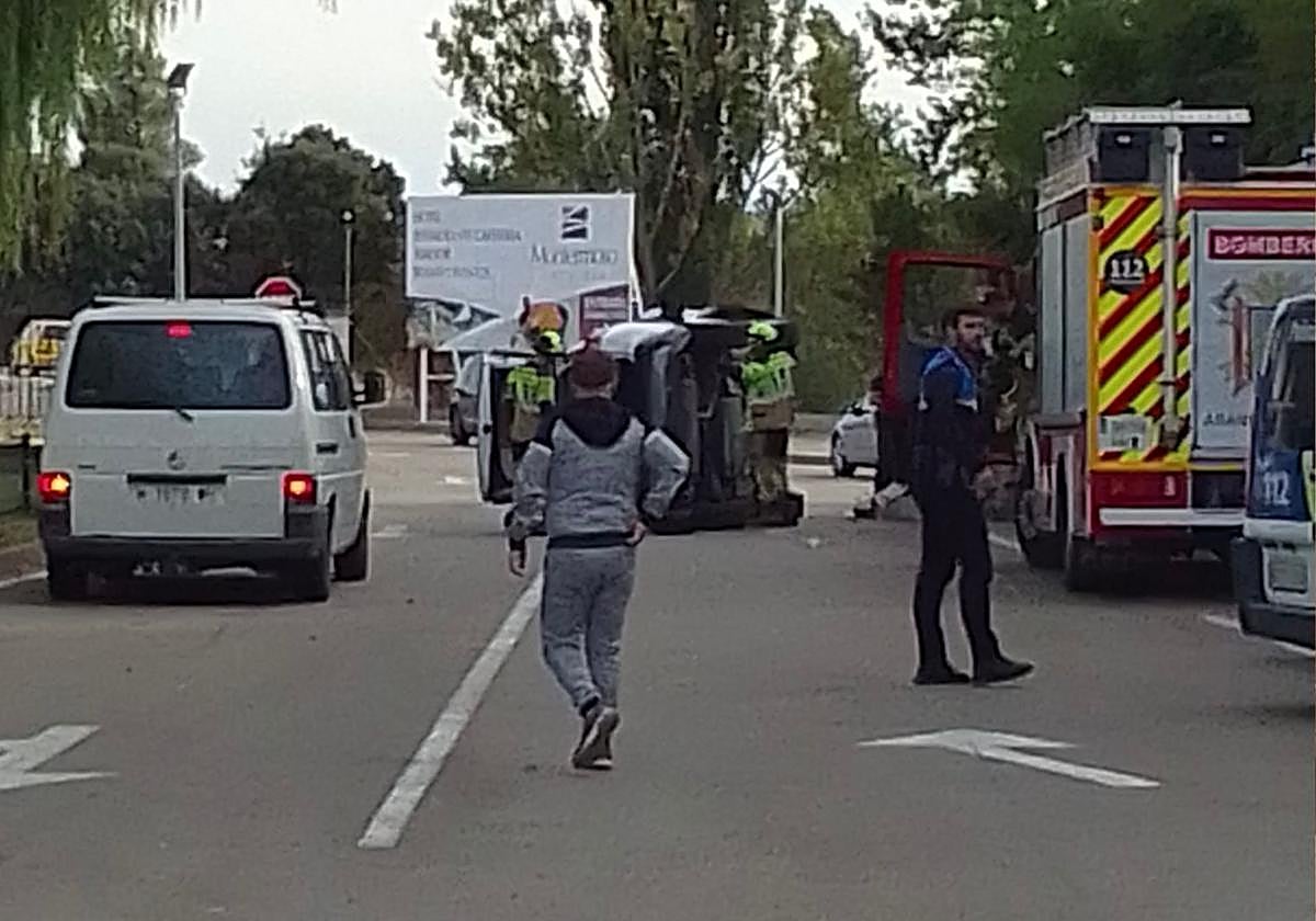 Bomberos de Aranda de Duero y Policía Local junto al turismo volcado a la entrada del hotel Montermoso.