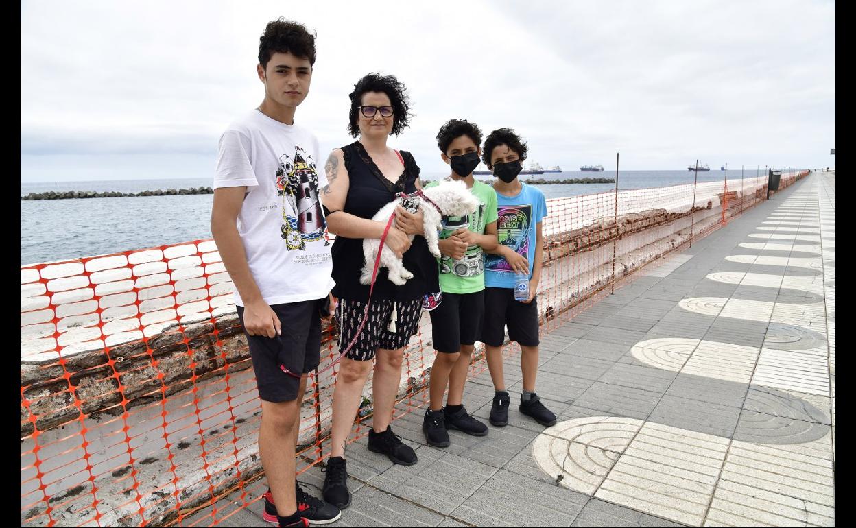 Zona vallada. Una familia pasea por uno de los tramos deteriorados. 