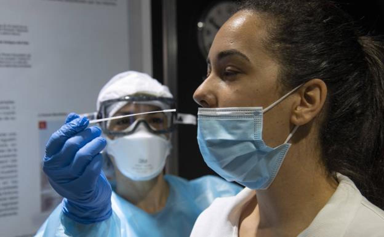 Una mujer sometiéndose a una prueba PCR para detectar la covid-19. 