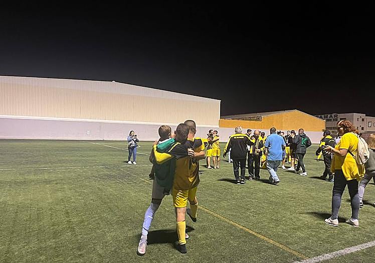 Abrazo entre jugadores de la UD San Nicolás tras conocer que subían a preferente.