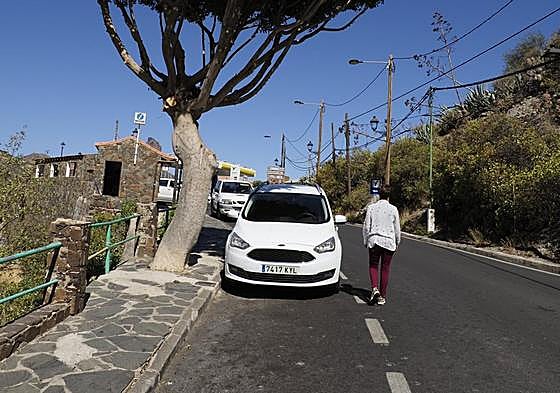 Los peatones transitan por la carretera debido a que vehículos, árboles, farolas y pérgolas no dejan más opciones.