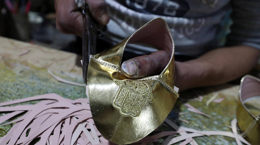 Un artesano fabrica zapatos tradicionales en un taller en el casco antiguo de Túnez, Túnez. Los zapatos de cuero tradicionales se fabrican para su venta a los turistas. En este taller se llegan a fabricar 60 pares de zapatos al día. 