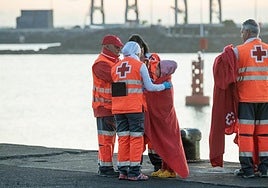 Imagen de archivo de una menor migrante junto a trabajadores de Cruz Roja en Lanzarote.