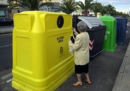 Imagen de archivo de una ciudadana depositando residuos en un contenedor.