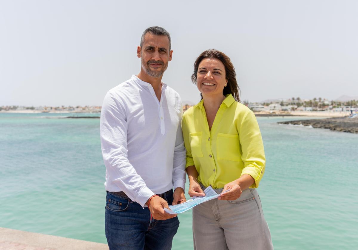 El alcalde Isaí Blanco y Omaira Saavedra, la edil de Festejos, en el muelle de Corralejo, con el programa de actos de las fiestas del Carmen.