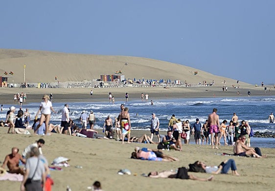 Turistas en la playa de Maspalomas, al sur de Gran Canaria, uno de los reclamos turísticos de la islas.