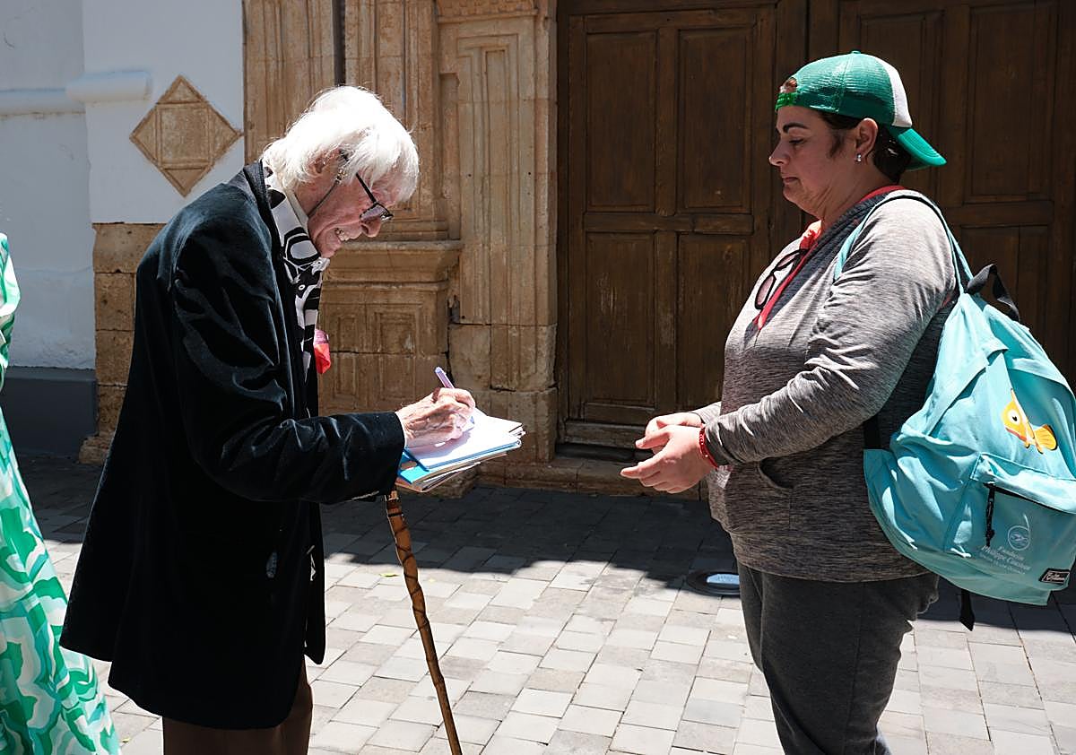 Imagen secundaria 1 - Dámaso explicó la portada de la iglesia de Pájara y hasta hizo un dibujo y firmó un autógrafo a una vecina de Pájara que se le acercó.