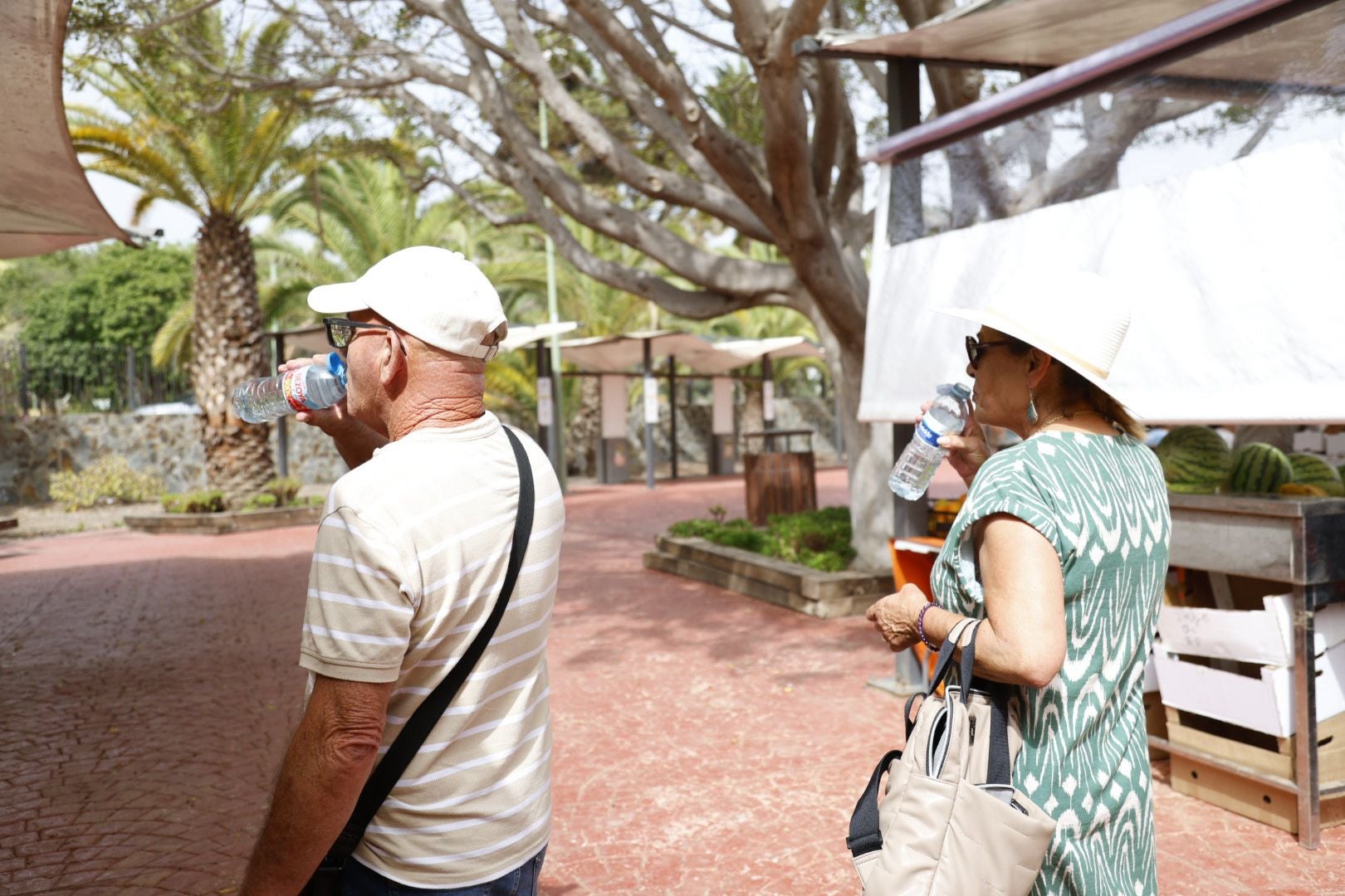 Pareja tinerfeña bebiendo agua y refugiándose del calor.