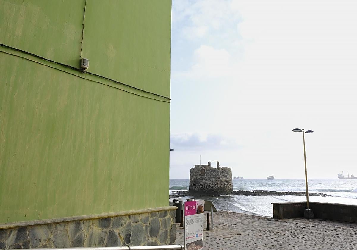 Vista del castillo desde un lateral del edificio a reformar, de color verde.