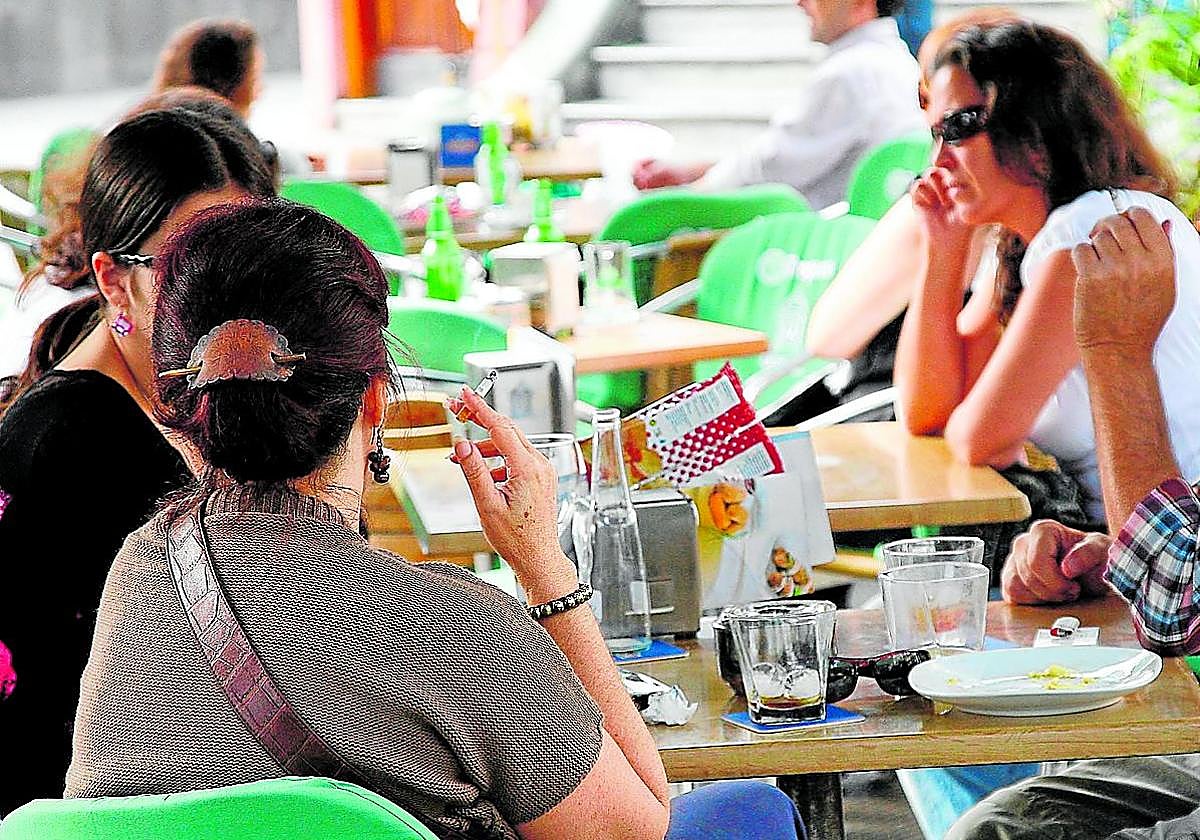 Fumadores en la terraza de una cafetería.