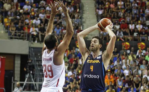 El pívot de la selección española de baloncesto Pau Gasol (d) de dispone a pasar un balón ante el tunecino Makram Romdhane.