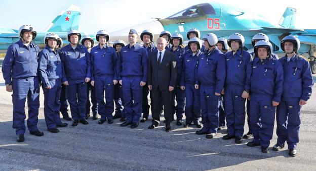 Putin posa con pilotos de los cazas rusos desplegados en la base aérea de Hmeimim, en Siria. :: M. Klimentyev / AFp