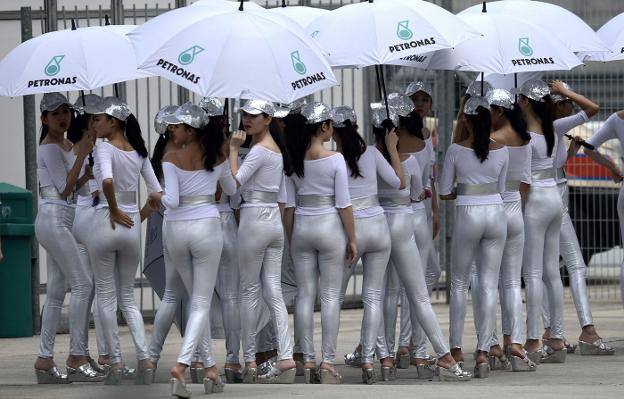 Paragüeras posan para la foto en el 'paddock' en el Gran Premio de Malasia en 2012. :: Saeed KHAN / afp