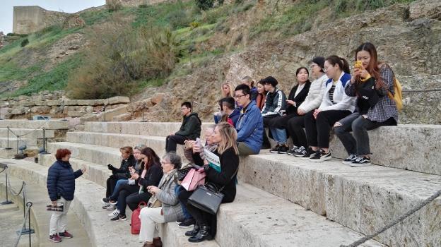 Los estudiantes de español del CIE-UMA, en la grada del Teatro Romano durante la visita. :: s. m.