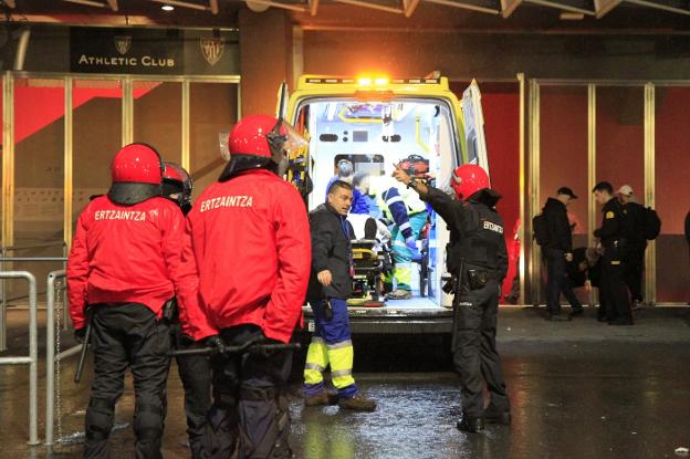 Uno de los vigilantes de seguridad heridos ayer es atendido en una ambulancia. :: MANU CECILIO