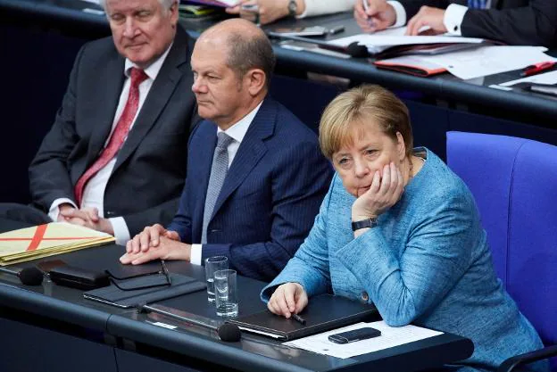 Merkel, junto a sus ministros de Finanzas y de Interior, ayer en el Parlamento alemán. :: efe