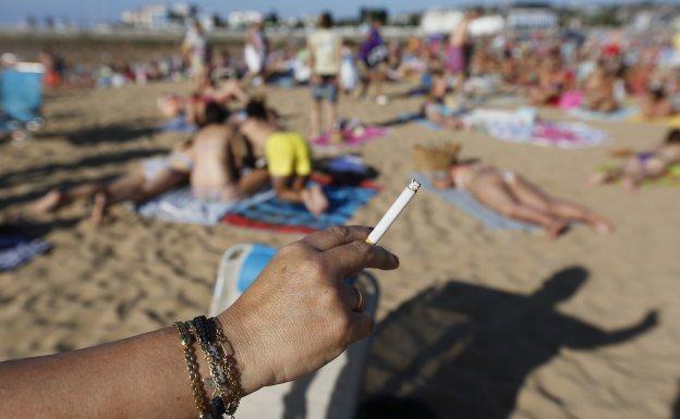 Una mujer sostiene un cigarrillo 