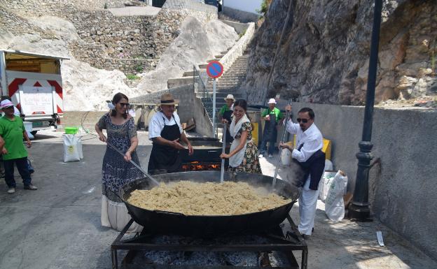 Imagen principal - Las delegadas de Turismo y Educación, arriba moviendo las migas este jueves, escenario con autoridades, debajo a la izquierda, y la pisadora de honor, en plena faena, a la derecha. 