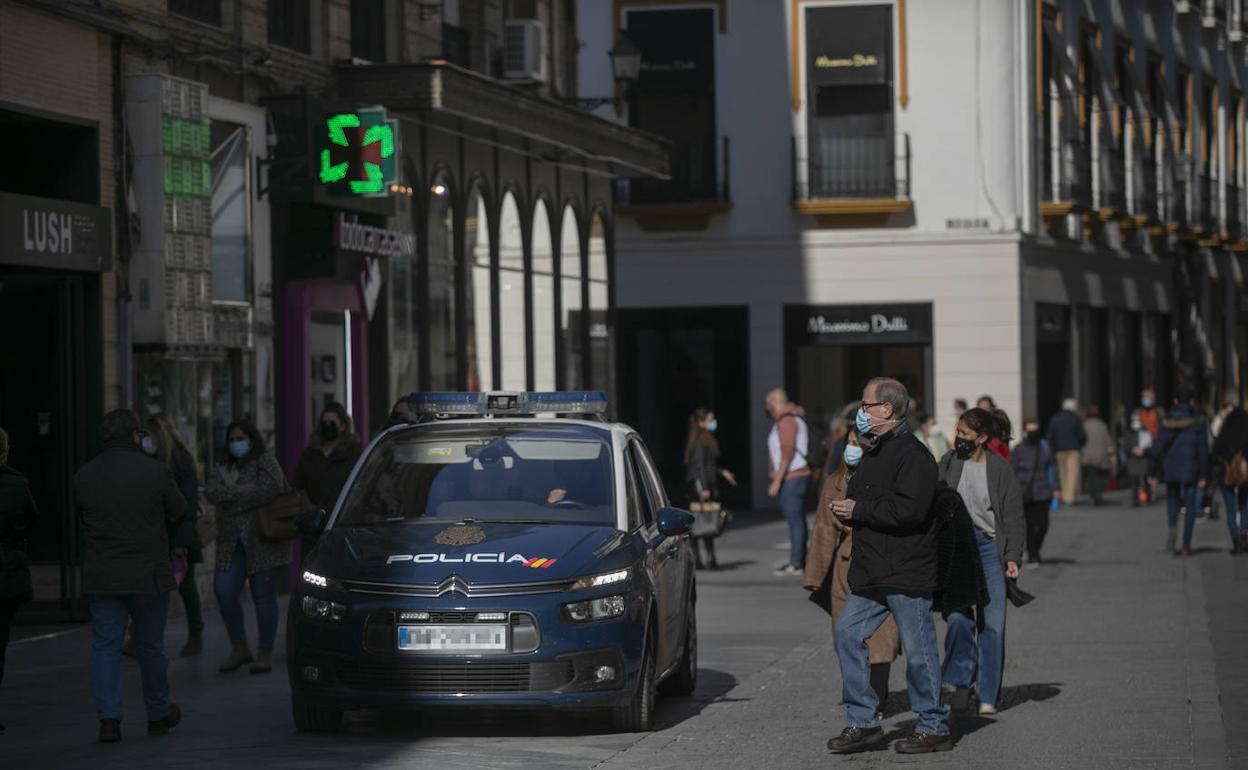 Un coche de policía en una calle sevillana 