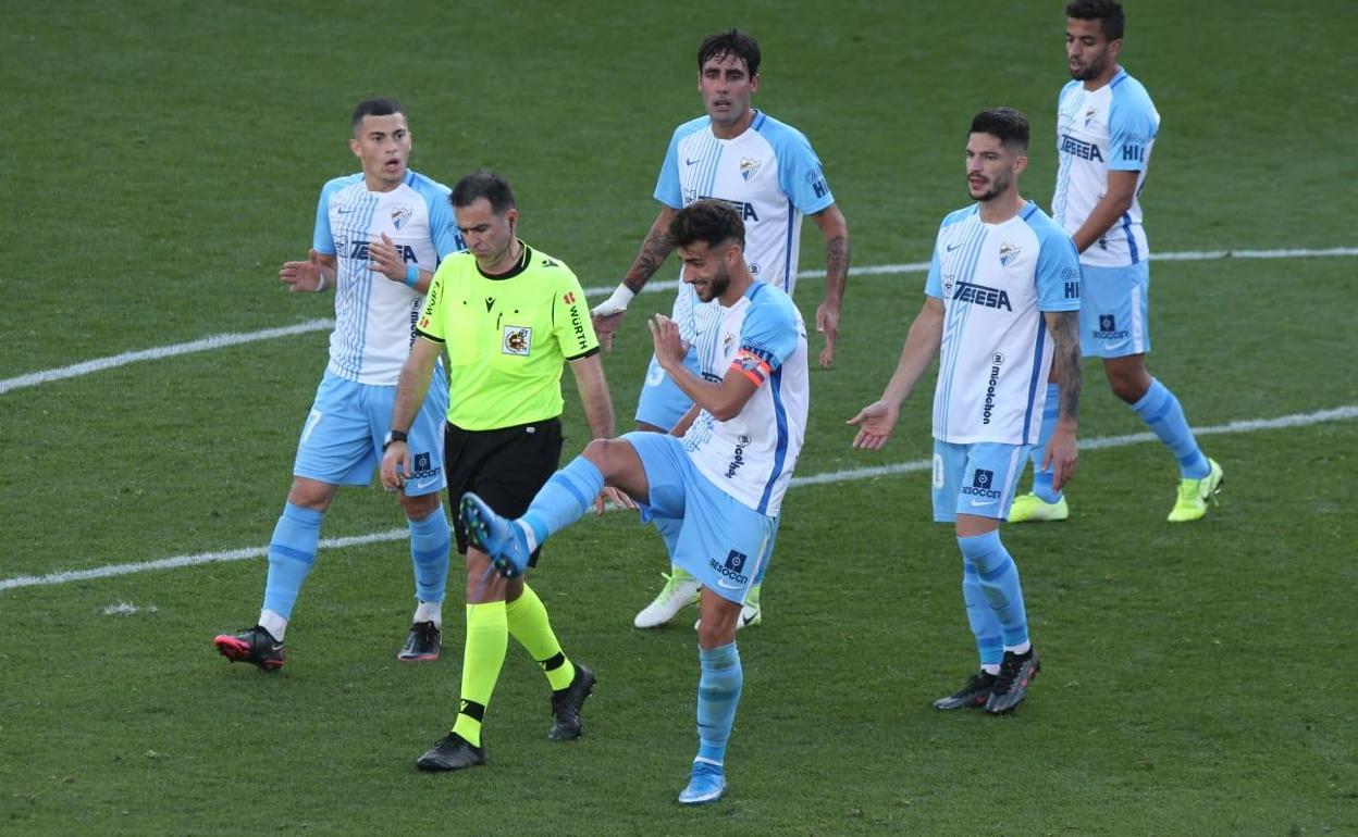 Luis Muñoz le muestra al árbitro su error al dar el gol del Tenerife, en una clara falta al portero. 