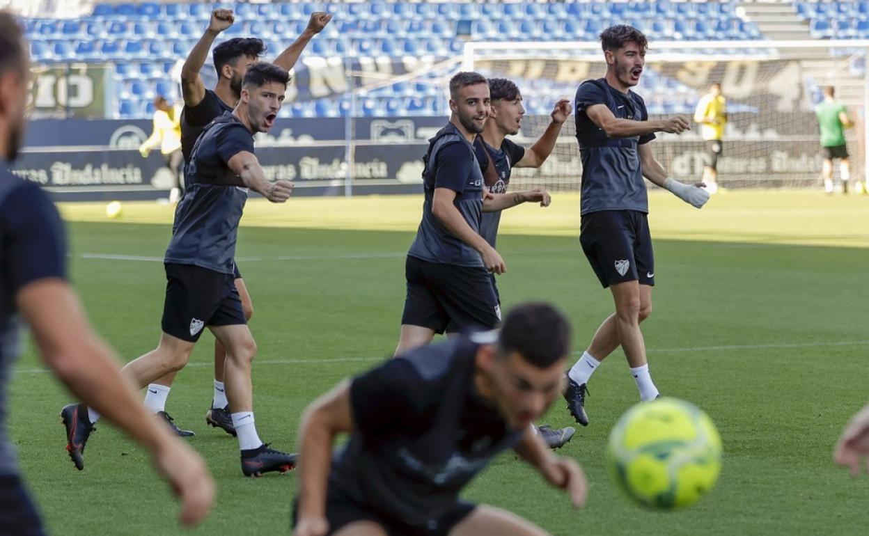 Los jugadores del Málaga Juande, Caye, Ismael, Larrubia y Jozabed, celebran durante uno de los ejercicios del entrenamiento de este domingo en La Rosaleda.