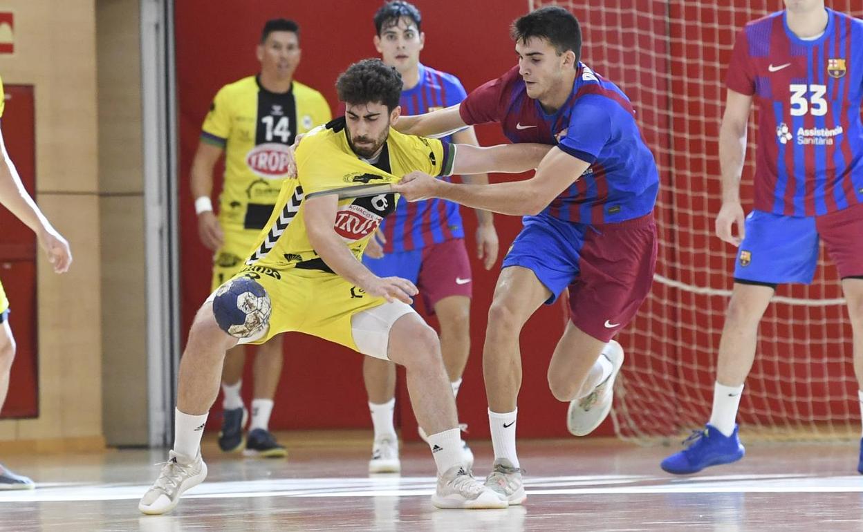 El antequerano del Barça B Palomino sujeta a Kahr, del Trops Málaga. 