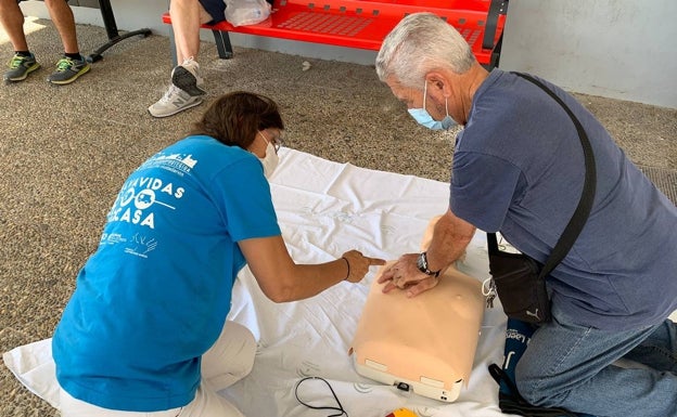 Una voluntaria de Expaumi enseña a dar masaje cardiaco. 