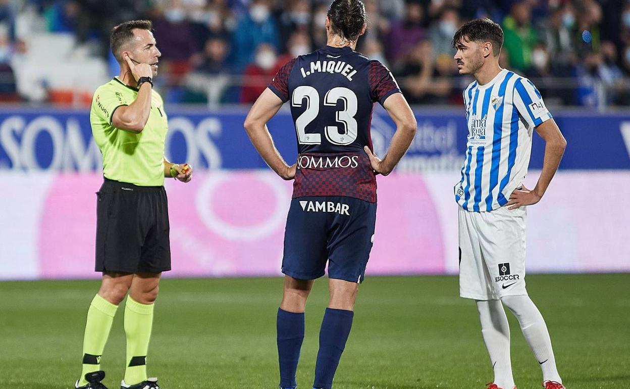 Gálvez Rascón escucha las indicaciones de Areces Franco desde la sala VOR, en presencia de Ignasi Miquel y Jozabed, en la jugada del gol anulado al Málaga en Huesca. 