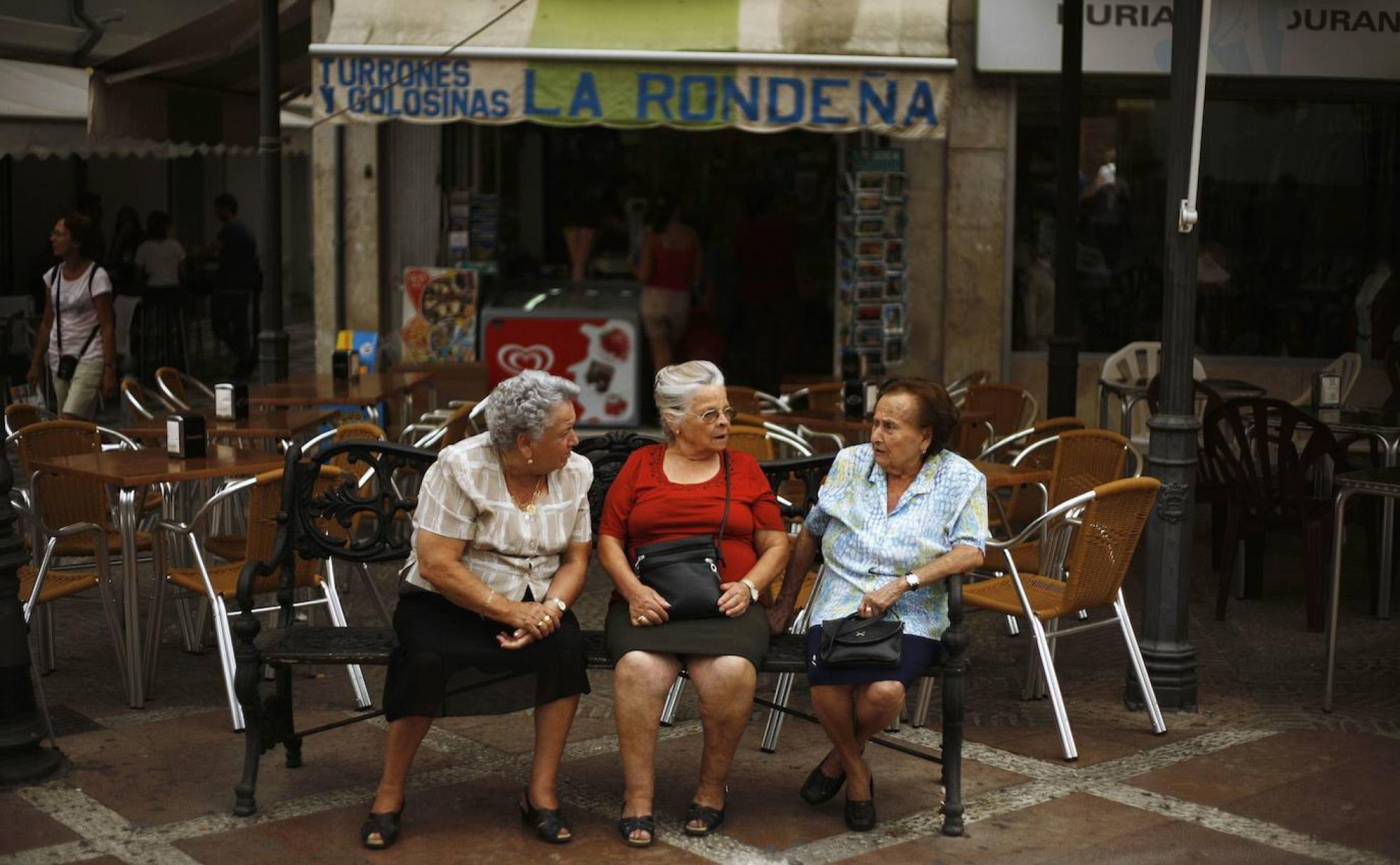 Tres jubiladas conversan en una calle de Ronda. 