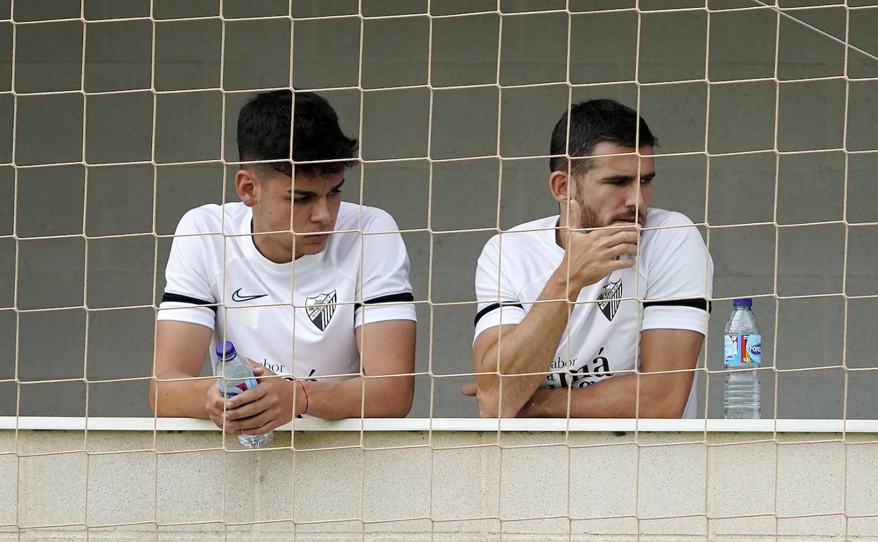 Andrés Caro y Jairo, esta mañana durante el entrenamiento del Málaga, al margen.