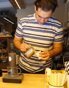 Imagen secundaria 2 - Ignacio (arriba), Leonardo y Eduardo (abajo) preparan un café en sus negocios. 