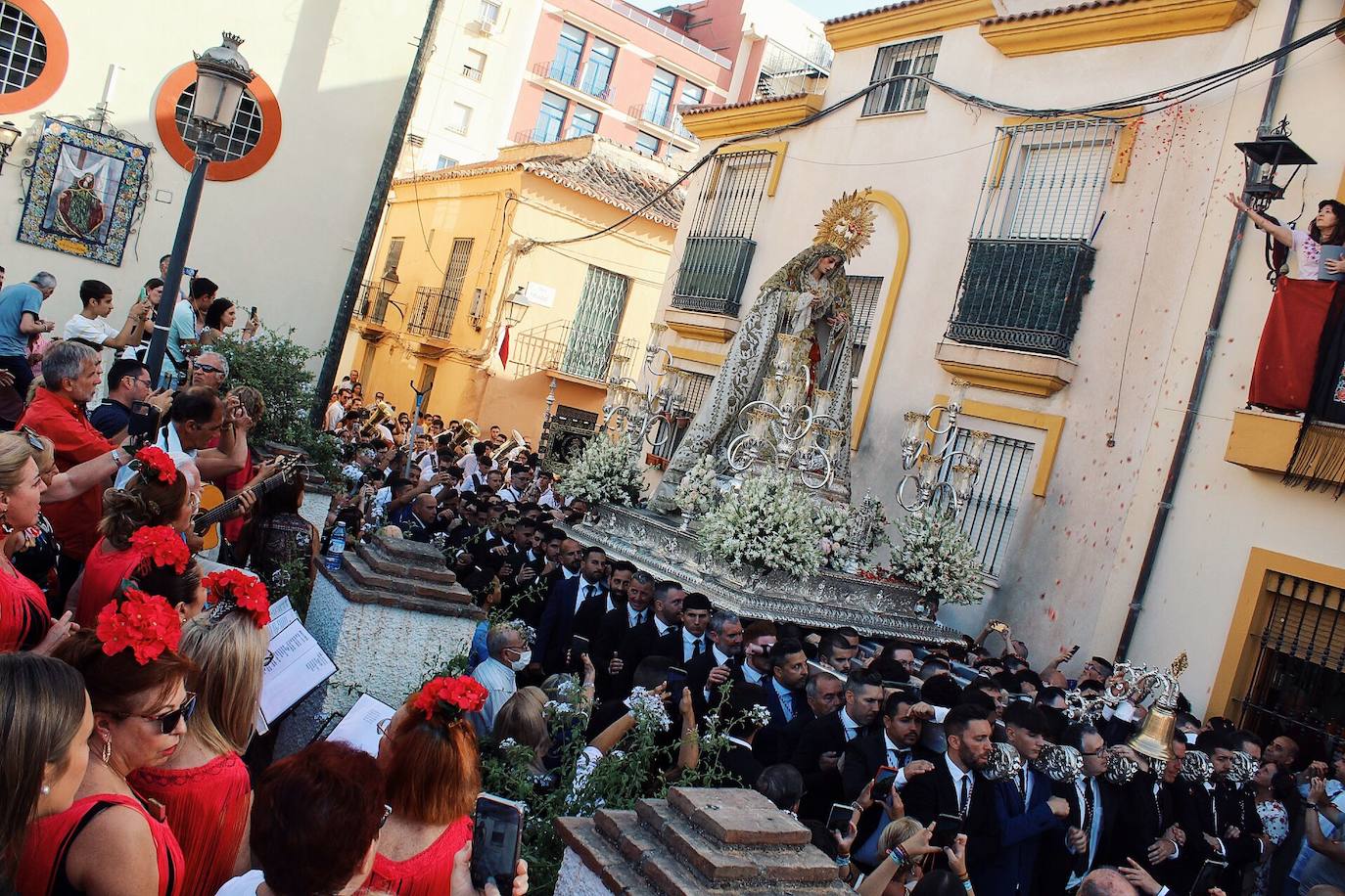 Detalles de la procesión de la Virgen de la Trinidad por las calles de su barrio. 