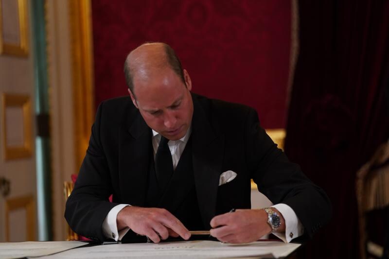El príncipe Guillermo firma el documento que proclama rey a su padre.