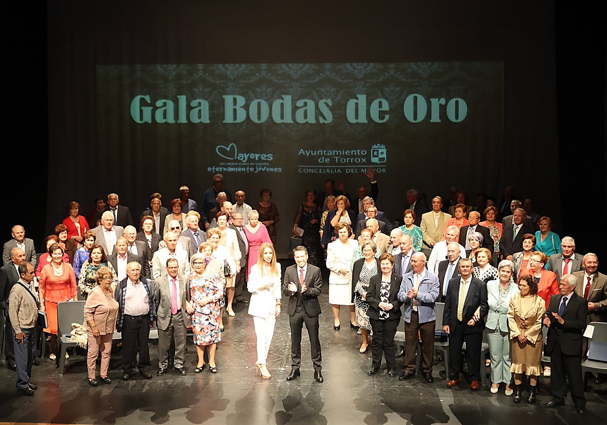 El centenar de mayores de Torrox homenajeados este sábado por el Ayuntamiento, en el escenario con el alcalde.