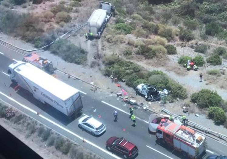 Imagen principal - Dos muertos y retenciones kilométricas en la AP-7 por la caída de un camión por un terraplén tras un accidente con dos coches