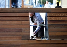 Un lector examina los títulos dejados en este punto de intercambios de libros del centro de Málaga.