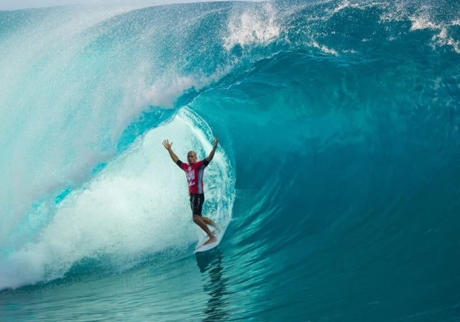 Kelly Slater sale dentro de un tubo en la ola de Teahupoo, donde se celebrará la prueba de surf de los Juegos de París.